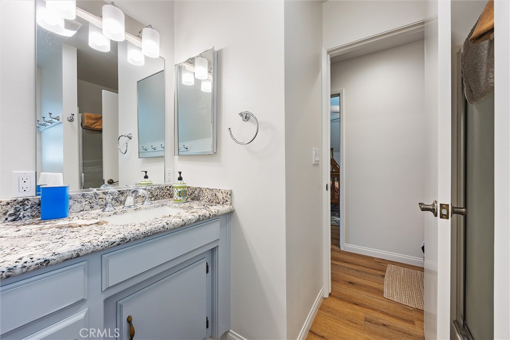 28207 Oaks Rancho Road Keene, CA 93531 - Photo 31 of 48 a bathroom with a granite countertop sink and a mirror