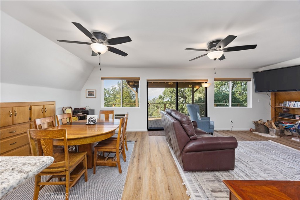 28207 Oaks Rancho Road Keene, CA 93531 - Photo 5 of 48 a living room with furniture a flat screen tv and a large window