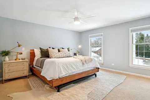 a spacious bedroom with a bed and window