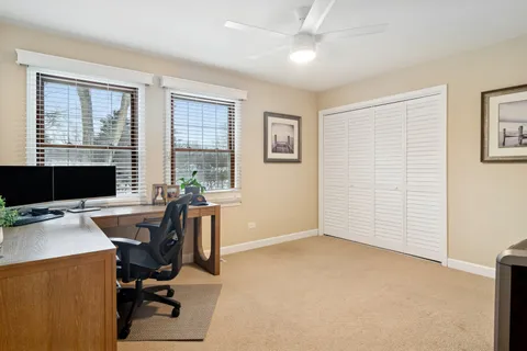 a view of a workspace with furniture and a window