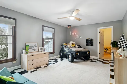 a living room with a bed furniture and a window