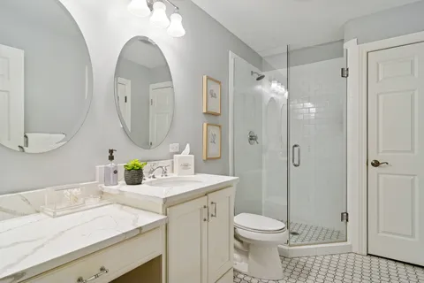 a bathroom with a sink a toilet and a mirror