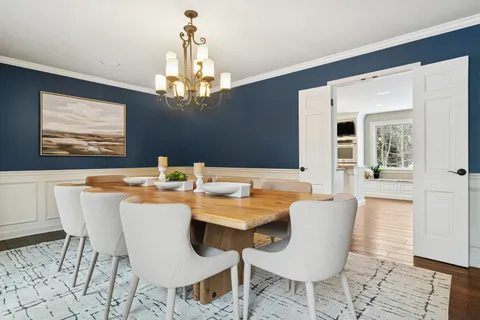 a view of a dining room with furniture wooden floor and chandelier