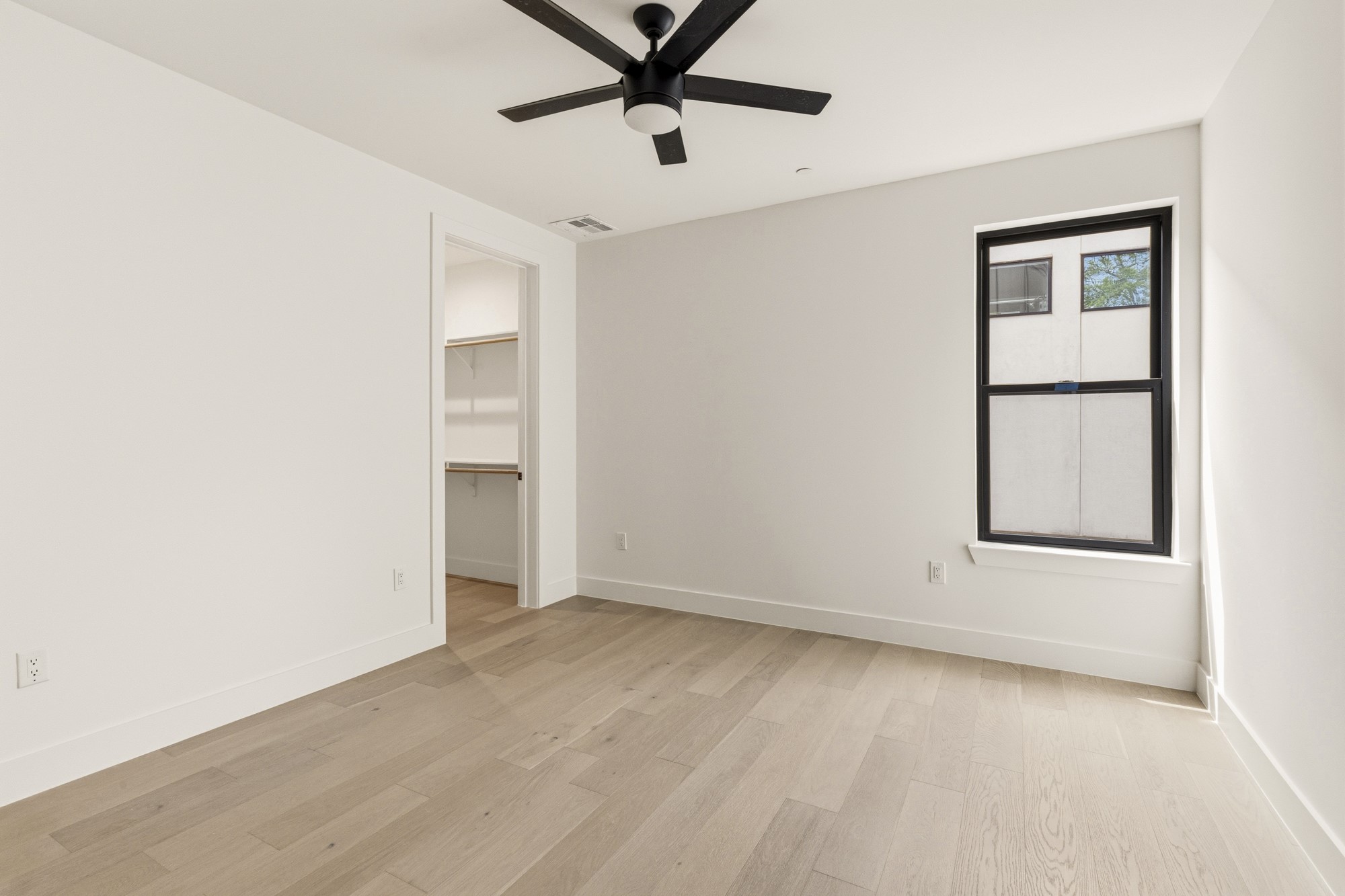 2300 Bluebonnet Lane Austin, TX 78704 - Photo 26 of 40 an empty room with a window and ceiling fan