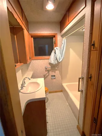 a bathroom with a sink a toilet and bathtub