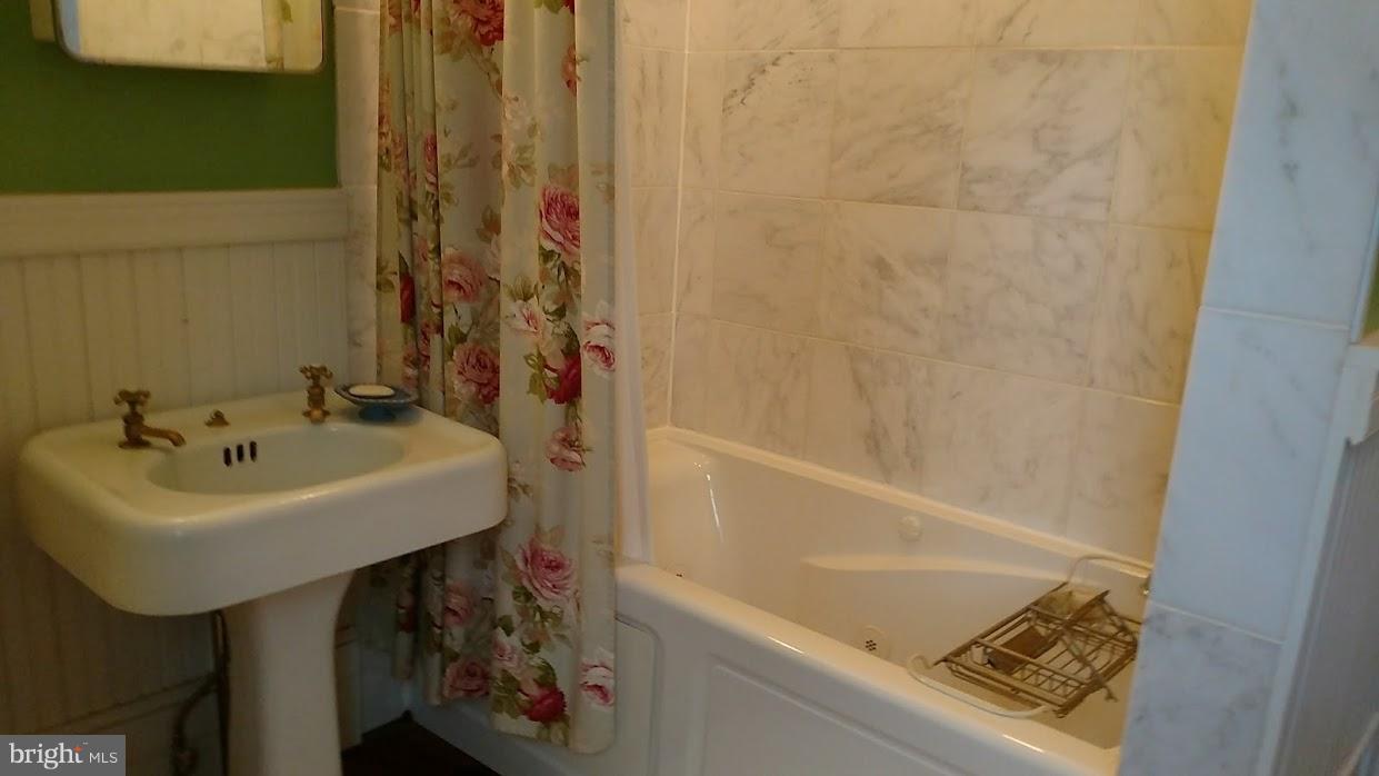 5246 Carroll Warehime Road Manchester, MD 21102 - Photo 14 of 30 a bathroom with a sink and a bathtub