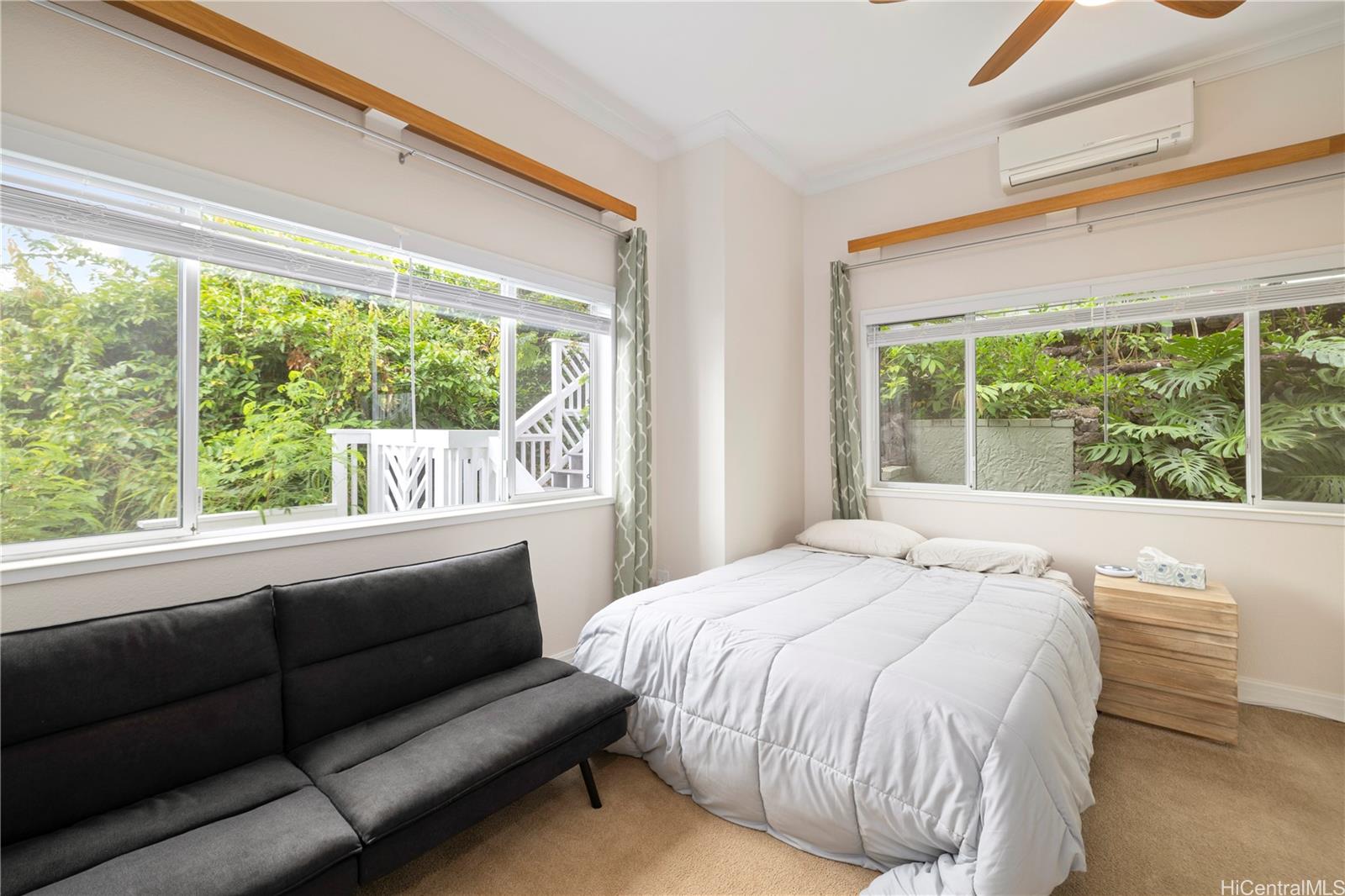 45-081 Lilipuna Road, Unit G Kaneohe, HI 96744 - Photo 12 of 25 a bed sitting in a bedroom next to a window