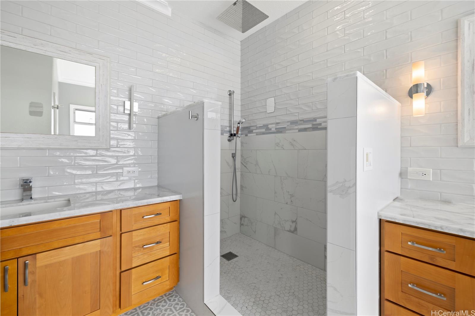 45-081 Lilipuna Road, Unit G Kaneohe, HI 96744 - Photo 17 of 25 a bathroom with a shower sink and mirror