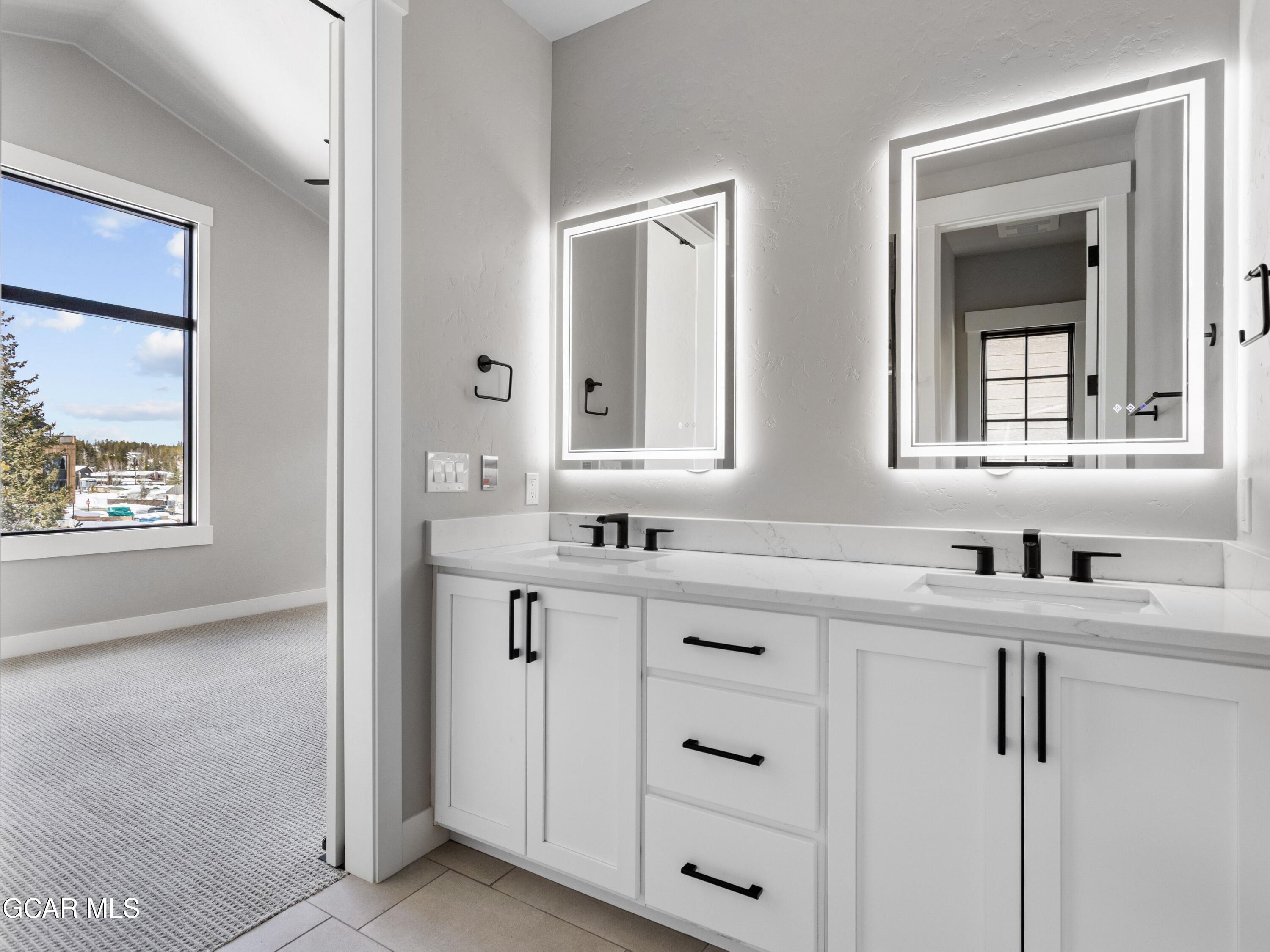 12 Exploration Trail Winter Park, CO 80482 - Photo 20 of 52 a bathroom with double sink and two mirror