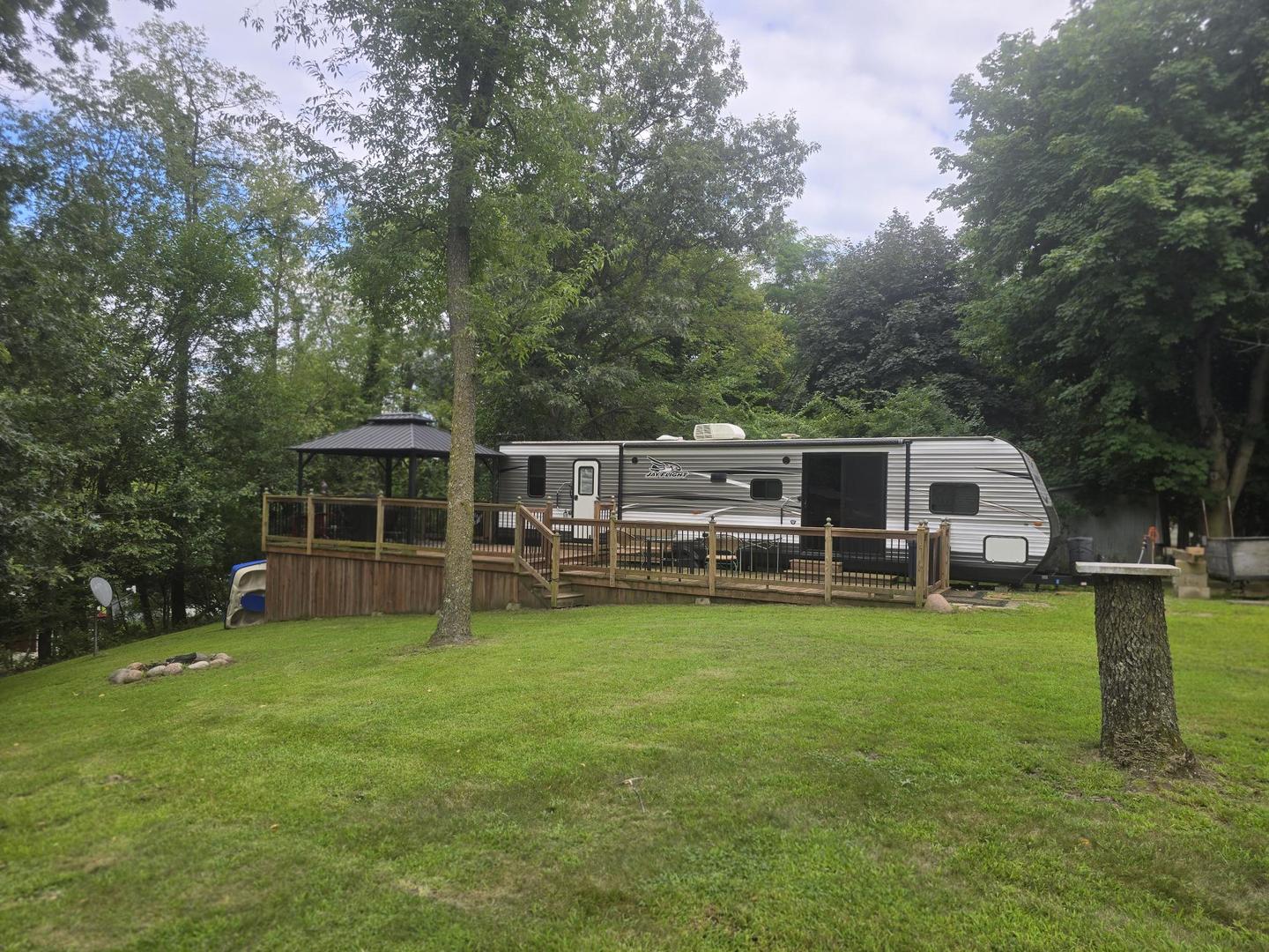 a view of a house with a big yard and large trees
