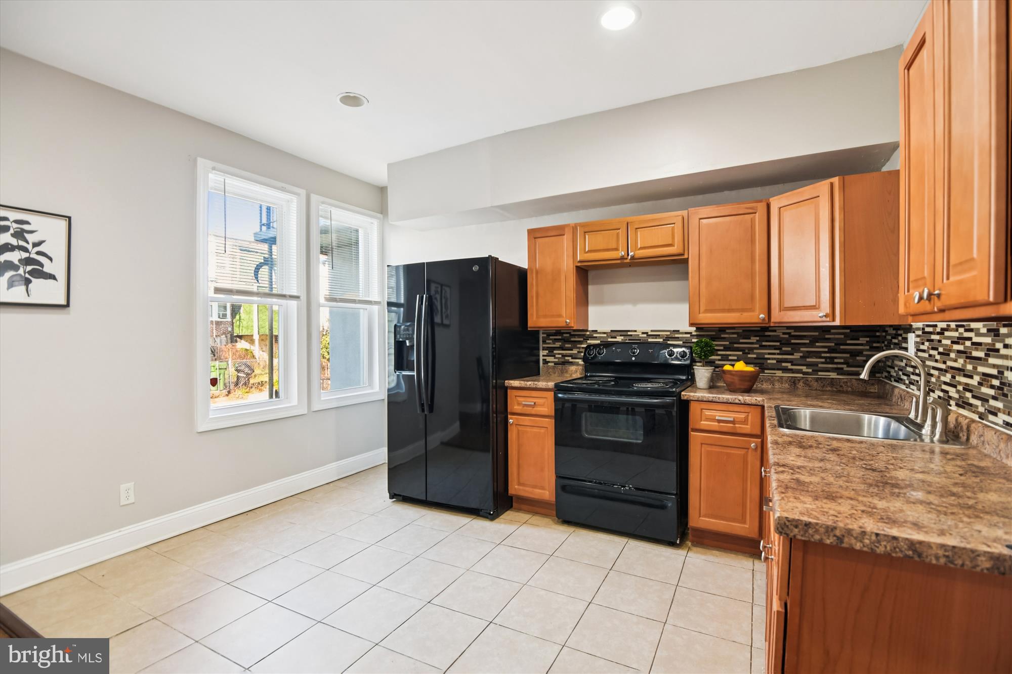 730 Edgewood Street Baltimore, MD 21229 - Photo 8 of 21 a kitchen with stainless steel appliances granite countertop a refrigerator stove and sink
