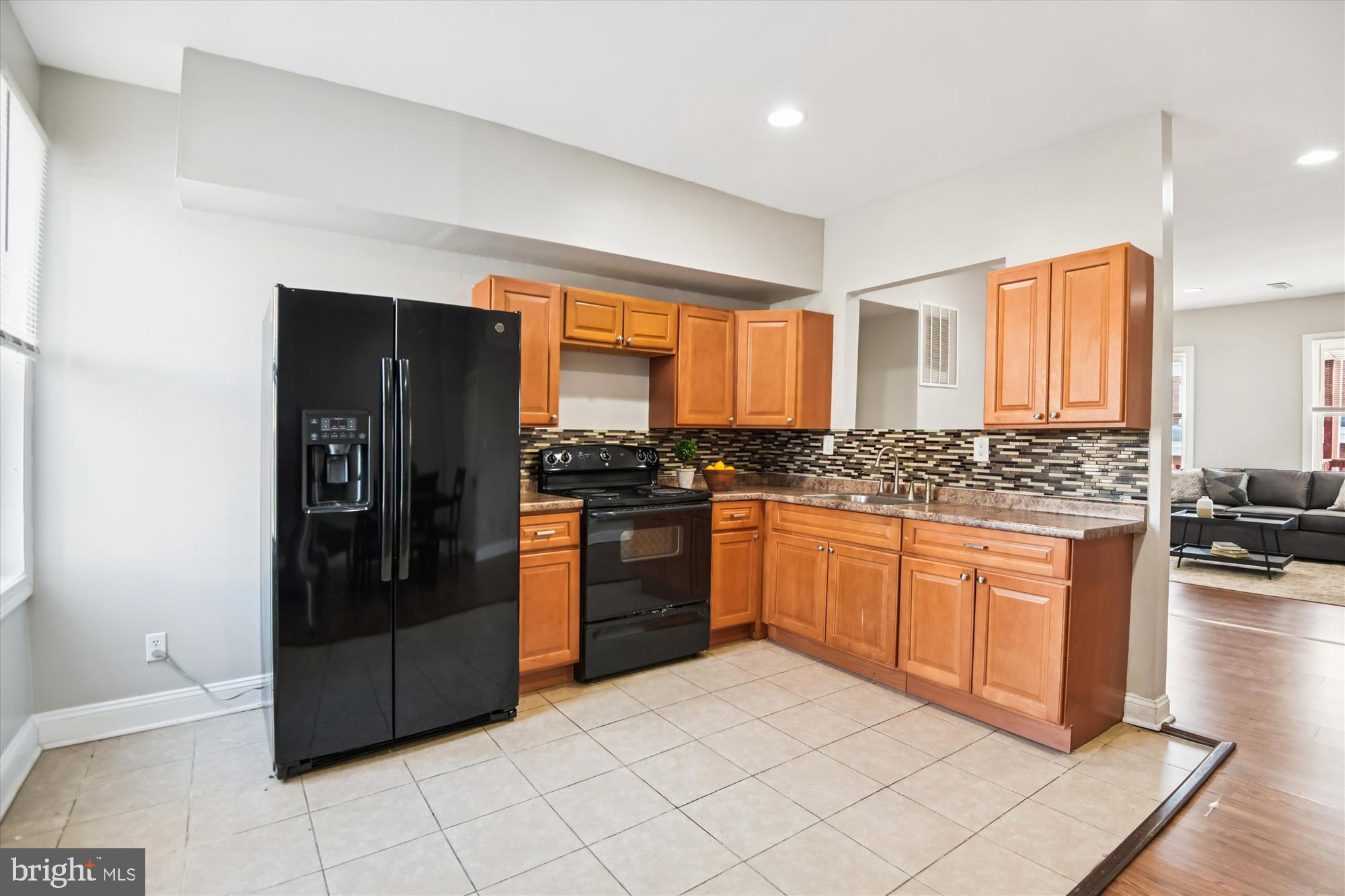 730 Edgewood Street Baltimore, MD 21229 - Photo 9 of 21 a kitchen with stainless steel appliances granite countertop a refrigerator and a stove top oven