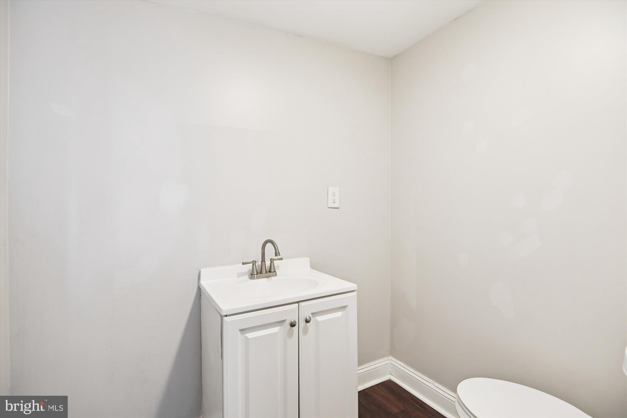 730 Edgewood Street Baltimore, MD 21229 - Photo 10 of 21 a bathroom with a toilet sink and mirror