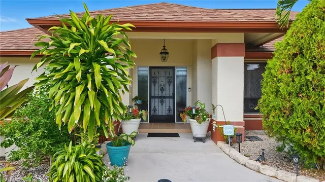 a front view of a house with a garden