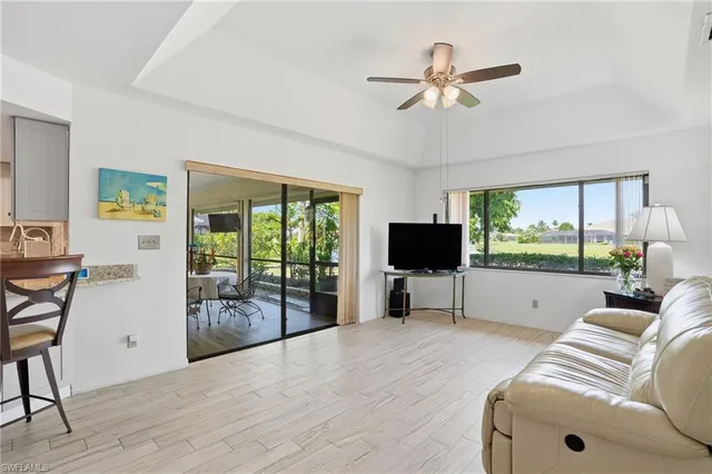 a living room with furniture tv and a large window