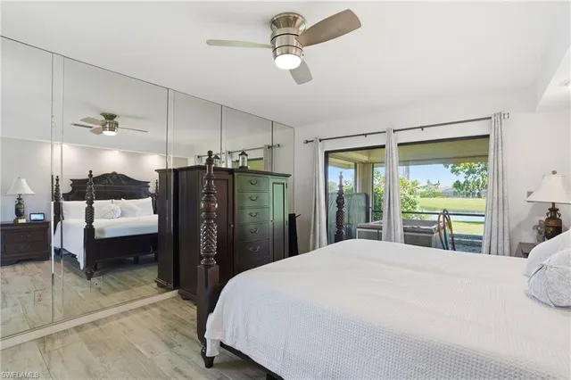 a bedroom with a bed mirror and window