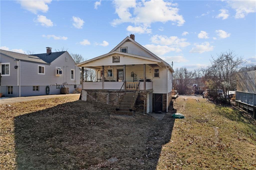 1906 Cliff Street Coraopolis, PA 15108 - Photo 30 of 39 a view of a big house with a big yard and large tree