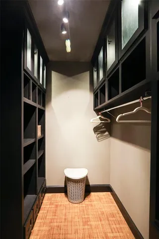 a bed sitting in a bedroom and a mirror