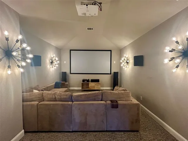 a bedroom with a bed and a flat tv screen on a dresser