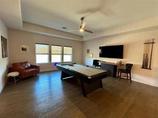 a bathroom with a granite countertop toilet sink and mirror