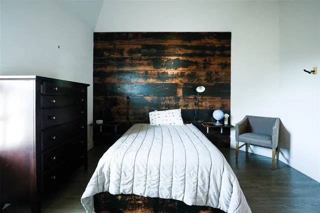 a bathroom with a granite countertop sink toilet and mirror