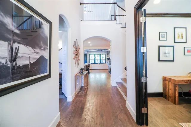 a view of a hallway view with wooden floor and staircase