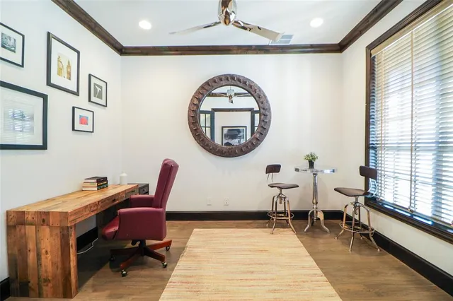 a living room with a piano a table and a large window