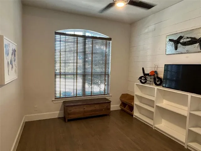 a bedroom with furniture and a window