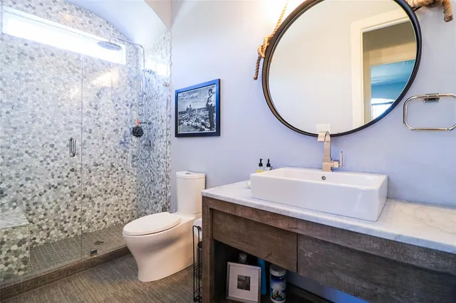 a bathroom with a sink mirror and toilet