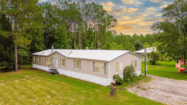 a aerial view of a house with swimming pool and yard
