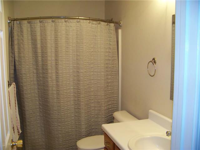 THIS FIRST BATH HAS A TUB/SHOWER COMBINATION.