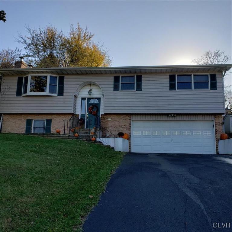 555 Bauer Road Bath, PA 18014 - Photo 3 of 36 a front view of a house with a garden and yard