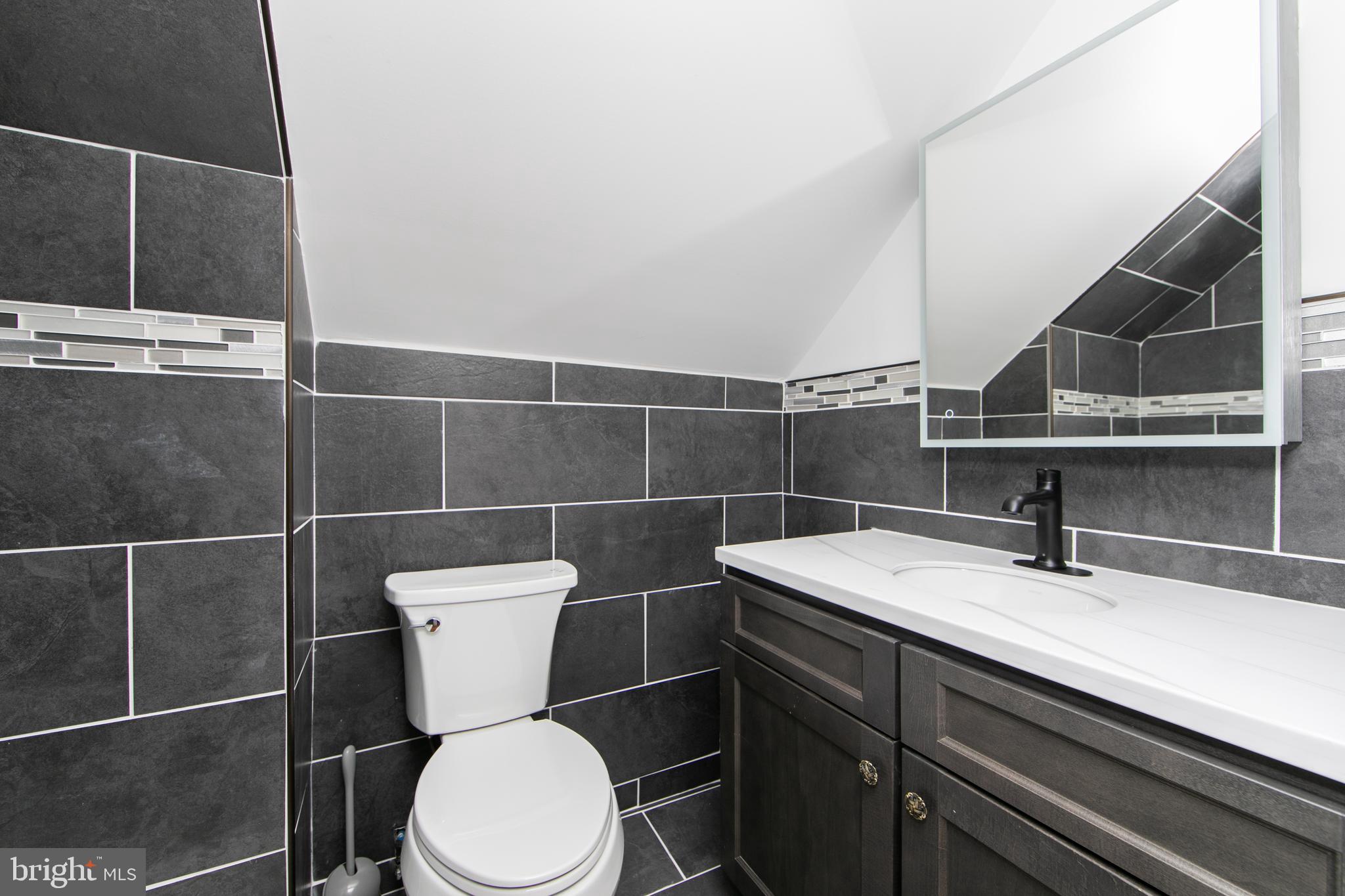 38 Lincoln Avenue Clementon, NJ 08021 - Photo 20 of 38 a bathroom with a toilet a sink and mirror
