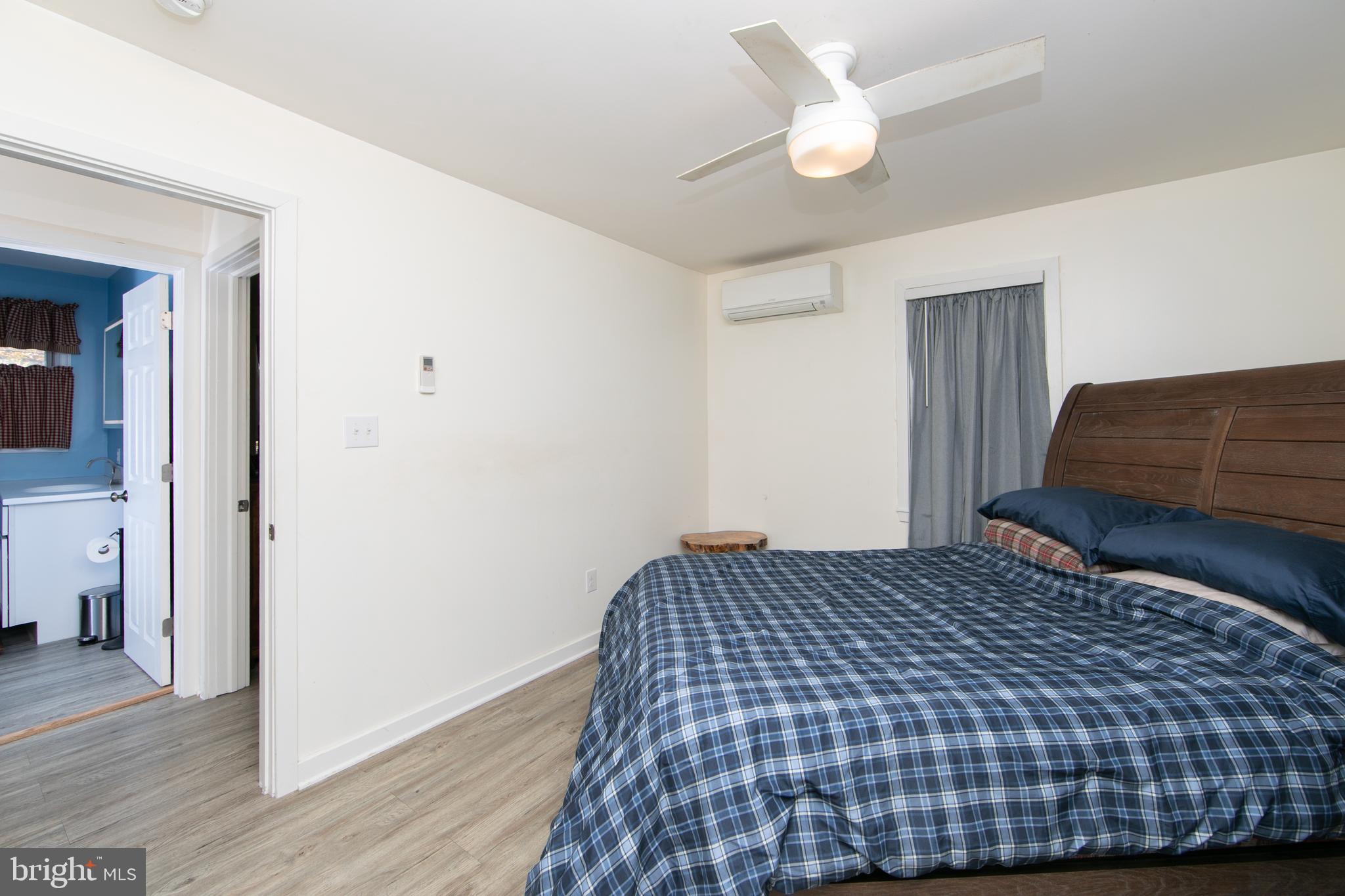 38 Lincoln Avenue Clementon, NJ 08021 - Photo 10 of 38 a bedroom with a bed and wooden floor