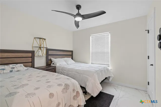 a bedroom with two beds and a chandelier
