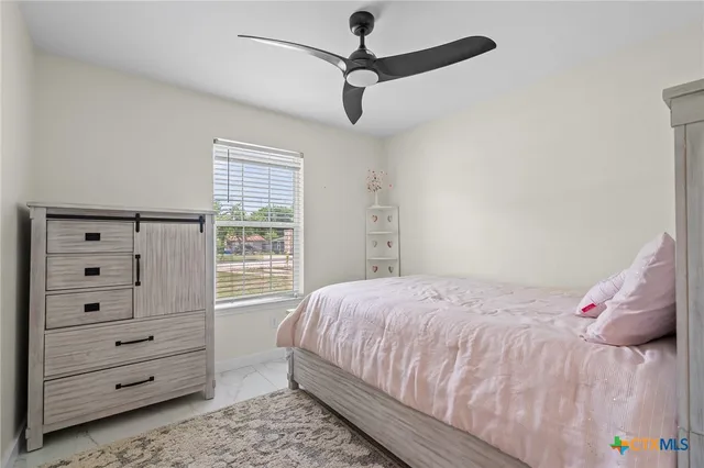 a bedroom with a bed and a dresser