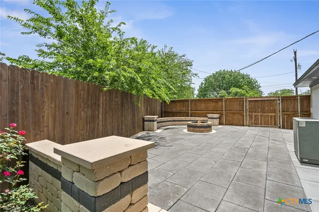 a backyard of a house with table and chairs