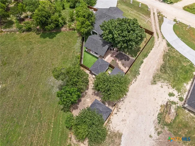 an aerial view of a house with a yard