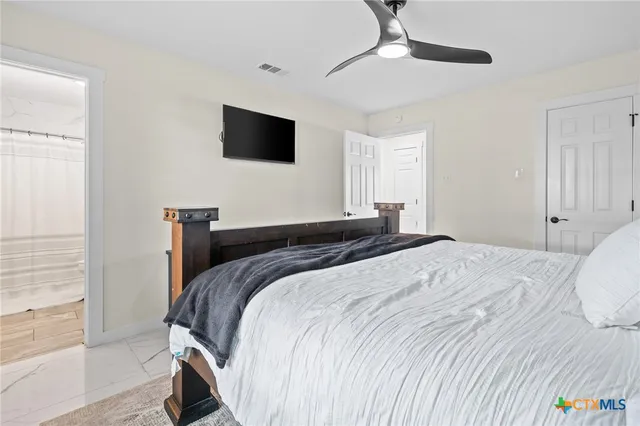 a bedroom with a bed and a flat screen tv