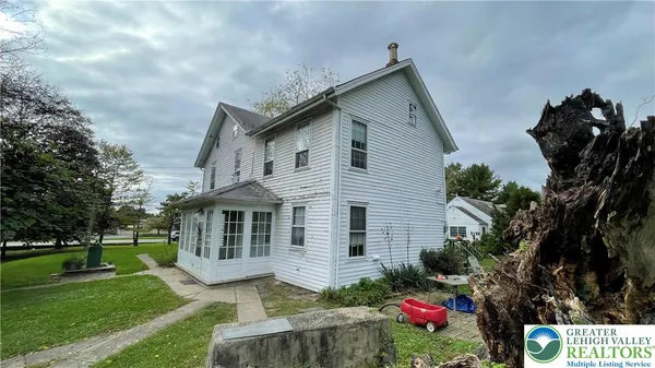 a front view of house with yard and green space