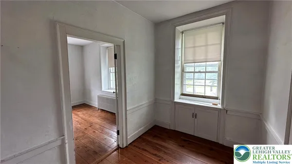 a view of an entryway with wooden floor