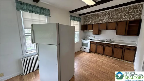a kitchen with stainless steel appliances a refrigerator and a stove top oven