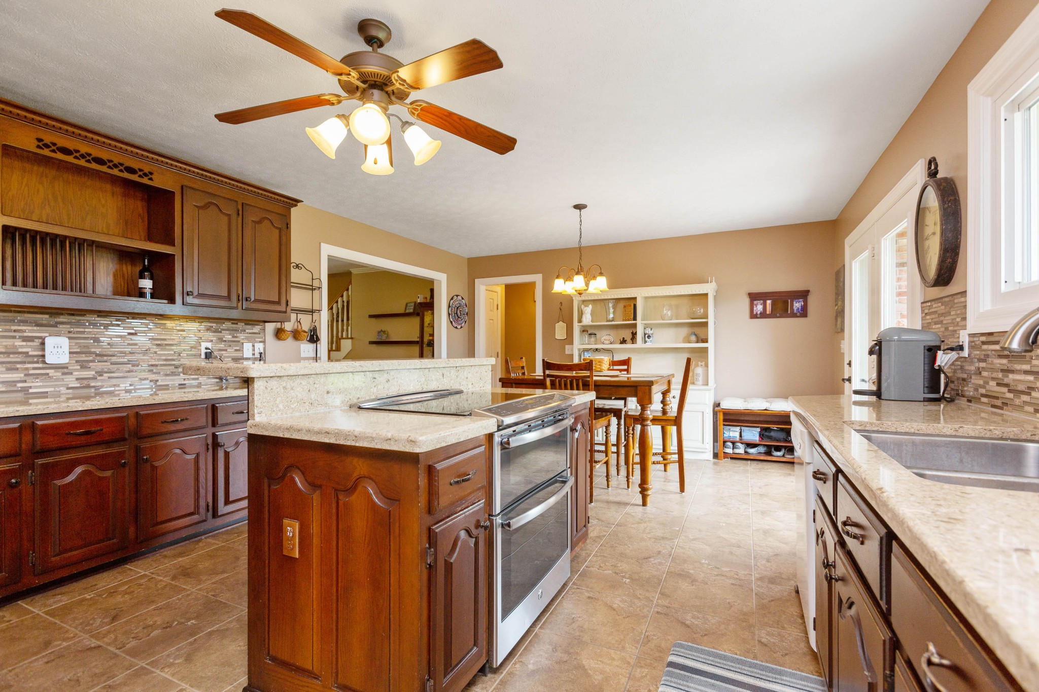 5059 Highpoint Road Pleasant View, TN 37146 - Photo 22 of 41 a kitchen with a stove top oven a sink a dining table and chairs