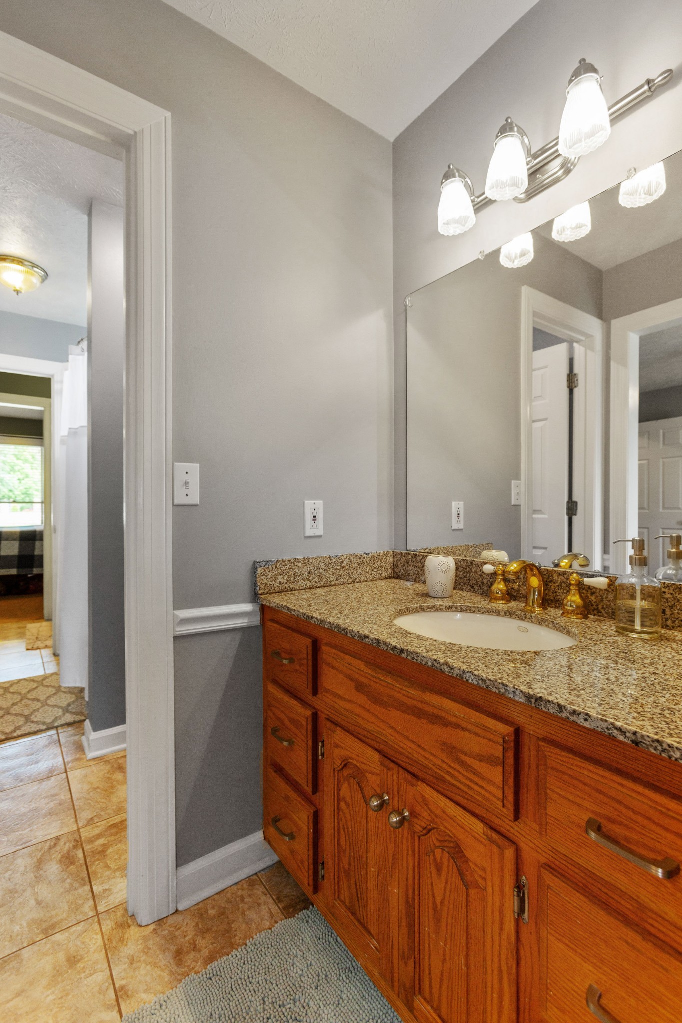 5059 Highpoint Road Pleasant View, TN 37146 - Photo 32 of 41 a bathroom with a granite countertop sink a light fixture and a mirror