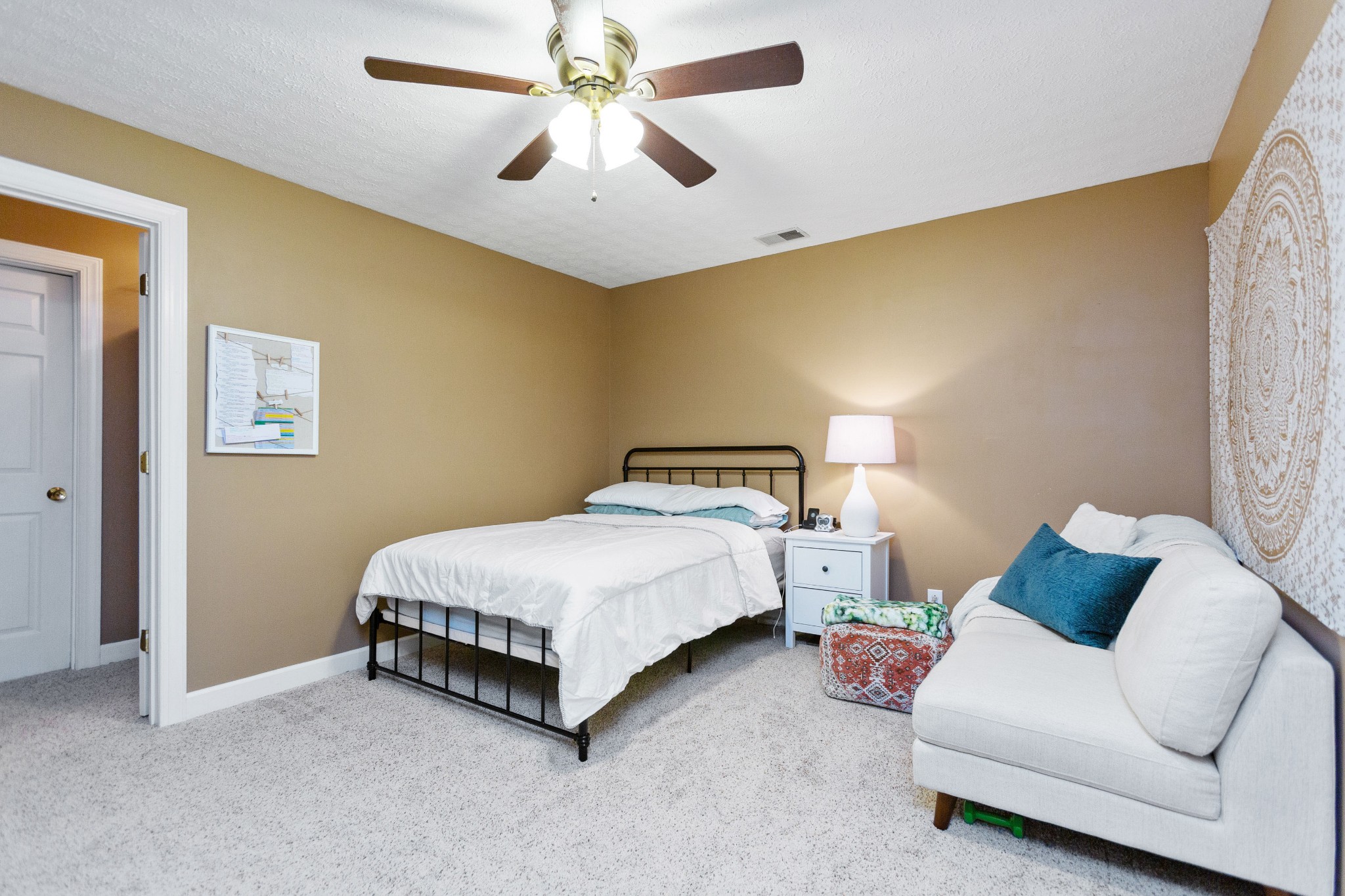 5059 Highpoint Road Pleasant View, TN 37146 - Photo 35 of 41 a spacious bedroom with a bed and a chandelier