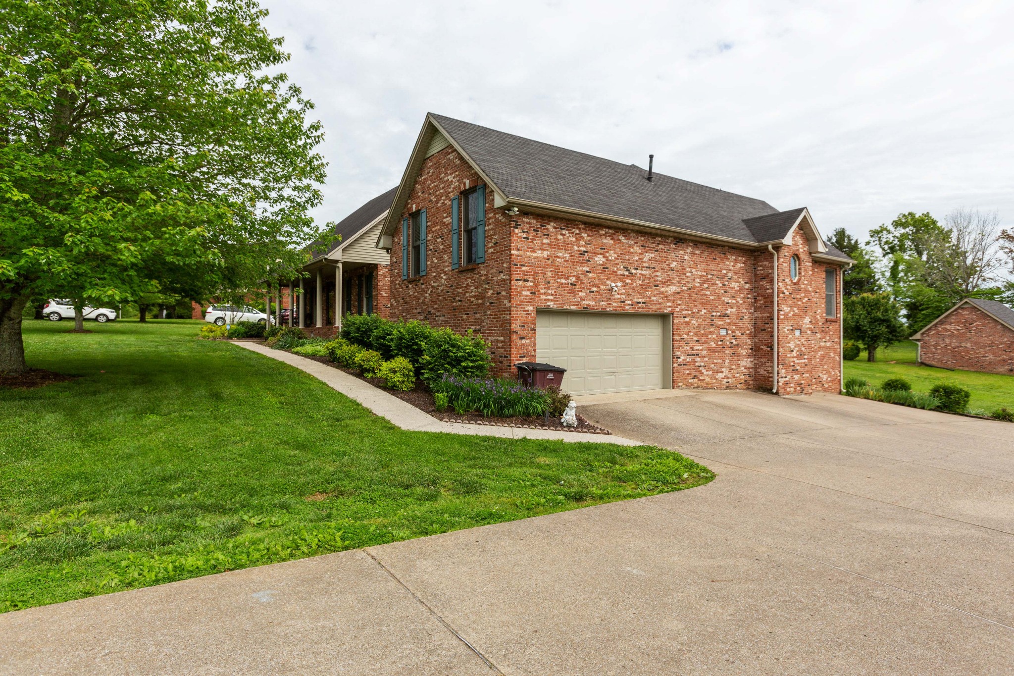 5059 Highpoint Road Pleasant View, TN 37146 - Photo 7 of 41 a front view of a house with a yard and garage