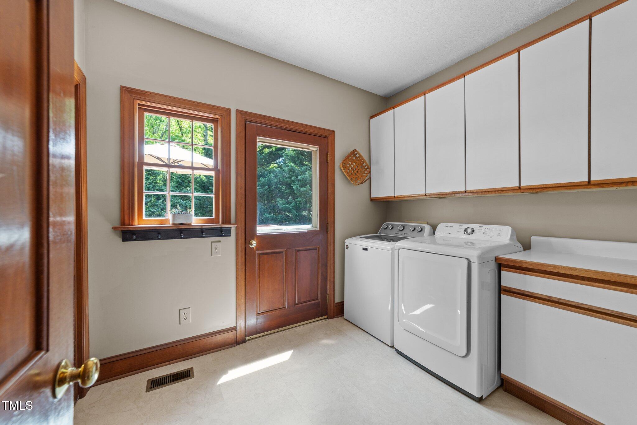 12200 Glenlivet Way Raleigh, NC 27613 - Photo 16 of 51 a utility room with dryer and washer