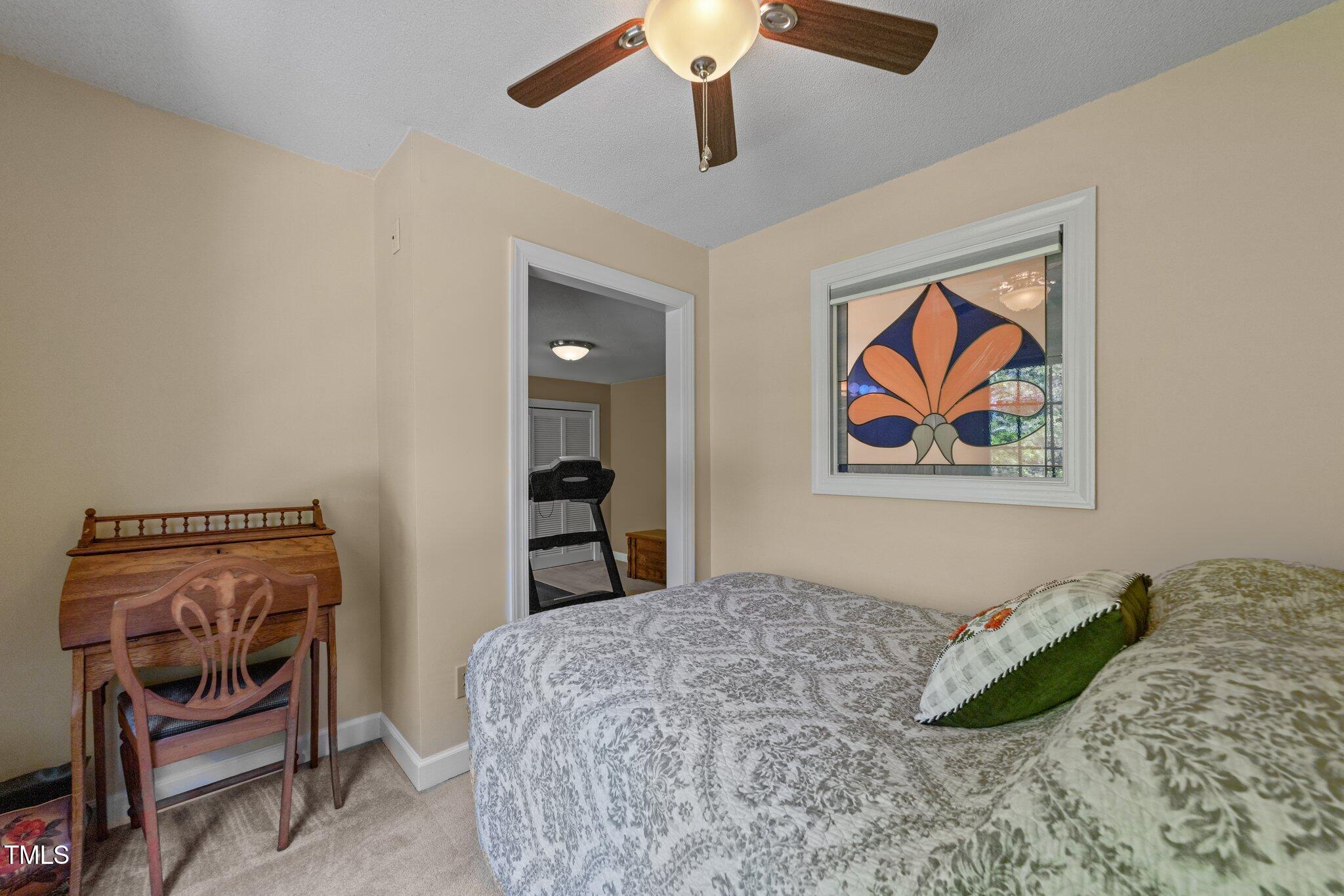 12200 Glenlivet Way Raleigh, NC 27613 - Photo 19 of 51 a bedroom with a bed and a painting on the wall