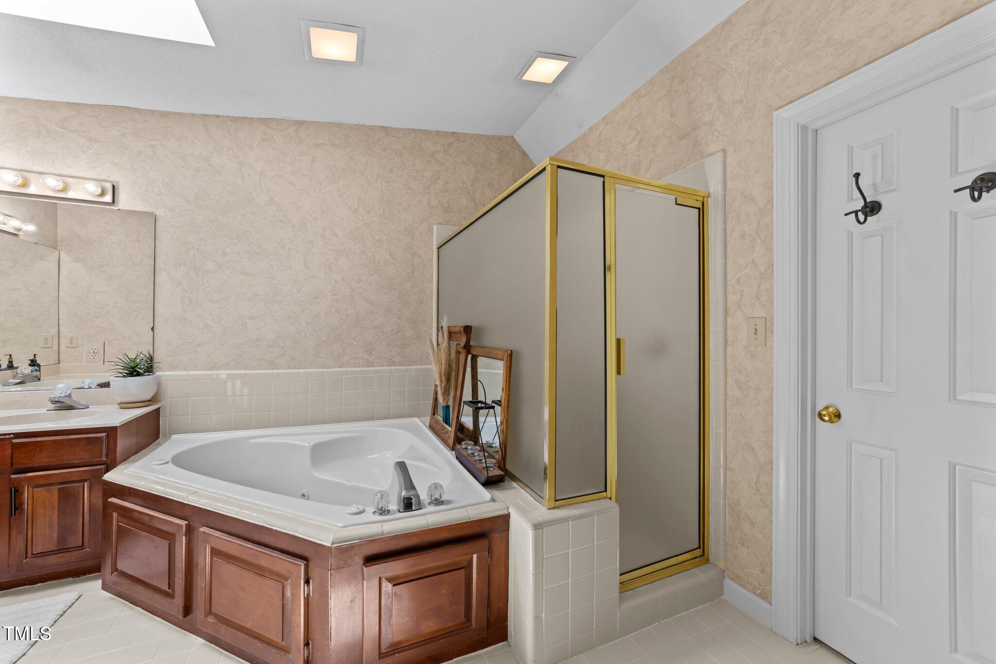 12200 Glenlivet Way Raleigh, NC 27613 - Photo 28 of 51 a bathroom with a tub sink and mirror
