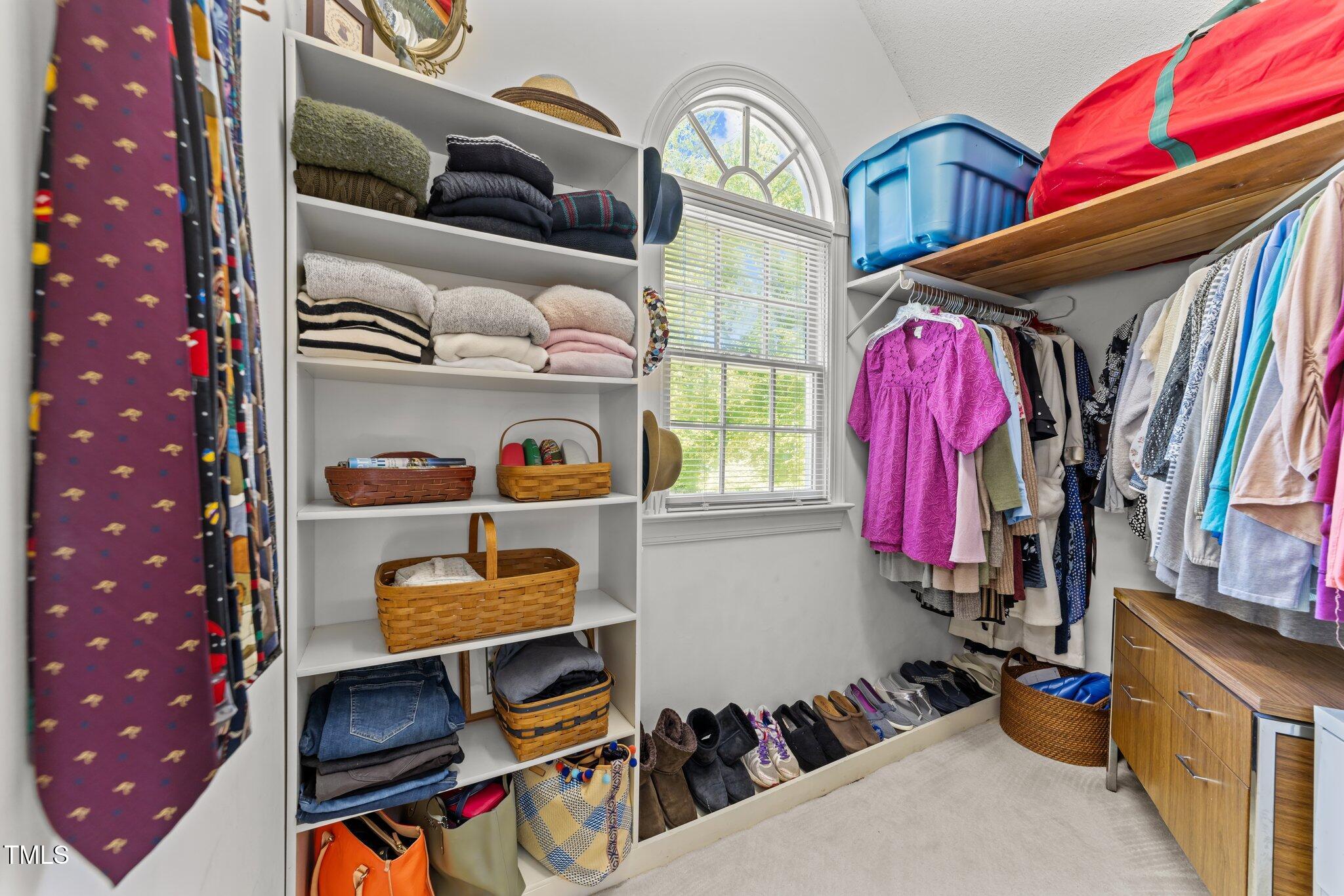 12200 Glenlivet Way Raleigh, NC 27613 - Photo 30 of 51 a view of walk in closet with clothes and shoes